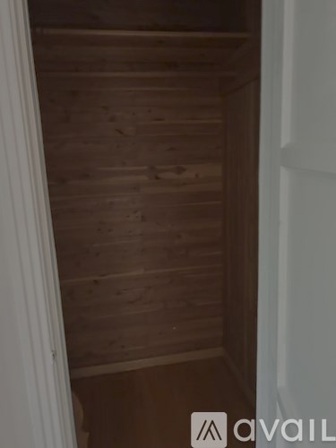 A wooden staircase leading to a white door.