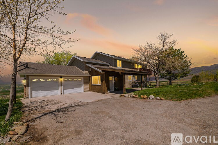 A house with a driveway and garage is available for sale.