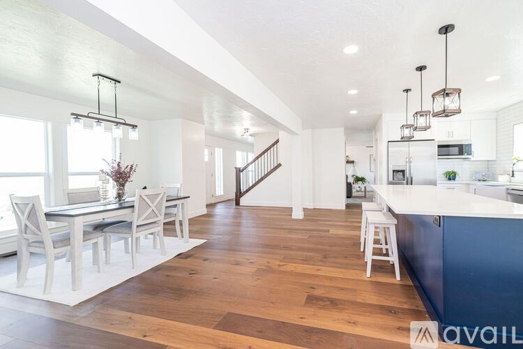 A modern kitchen with a dining table and chairs.