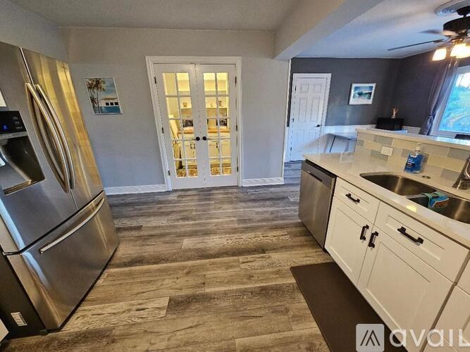A kitchen with a refrigerator on the left and a counter on the right.