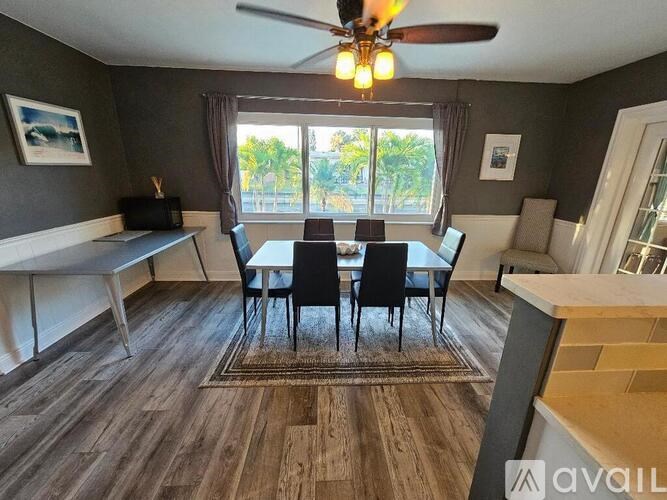 A dining room with a table set for four.