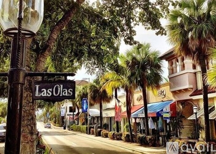 A street sign for Las Olas is seen in front of a palm tree.