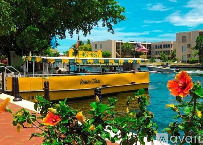 A yellow boat named Water Taxi is docked in a harbor.