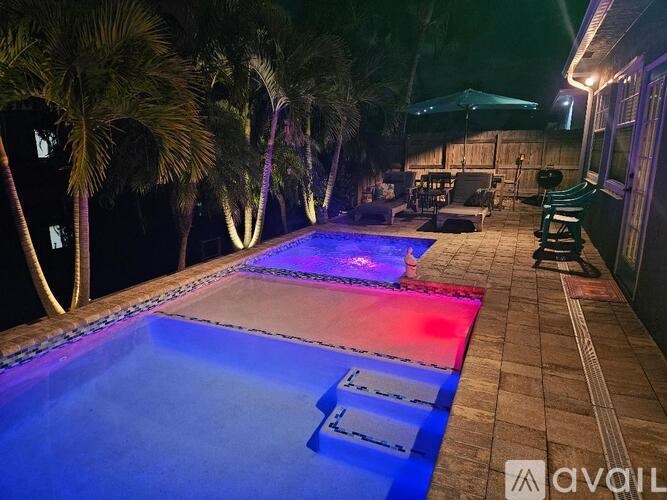 A pool with a blue and red light at the bottom.