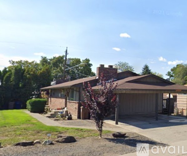 A house with a brown roof and a brown garage door is for sale.