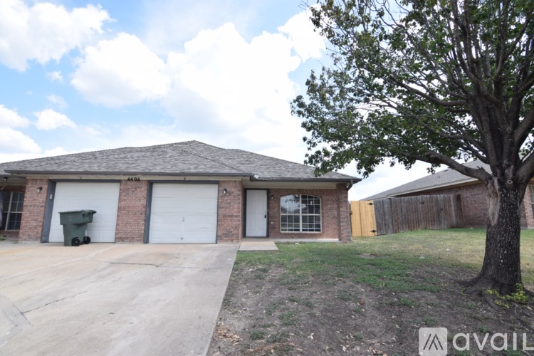 A house with a tree in front of it.