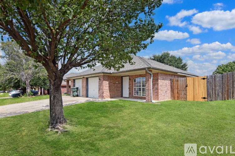 A house with a tree in front of it.