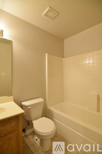 A bathroom with a toilet, sink, and bathtub.