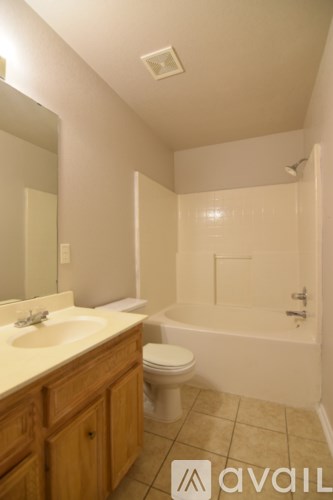 A bathroom with a toilet, sink, and bathtub.