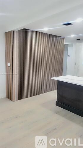 A room with a brown striped wall and a white counter.