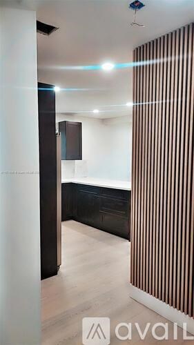 A room with a striped curtain and a cabinet.