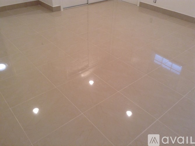 A room with a light-colored floor and a few light fixtures.