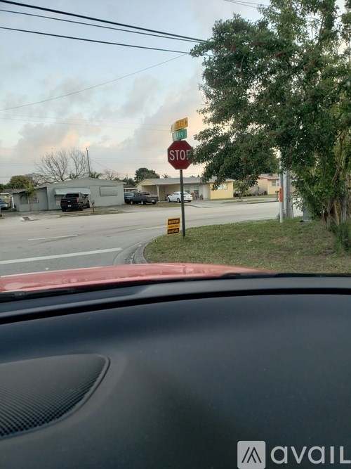 A stop sign is on a pole at a street corner.