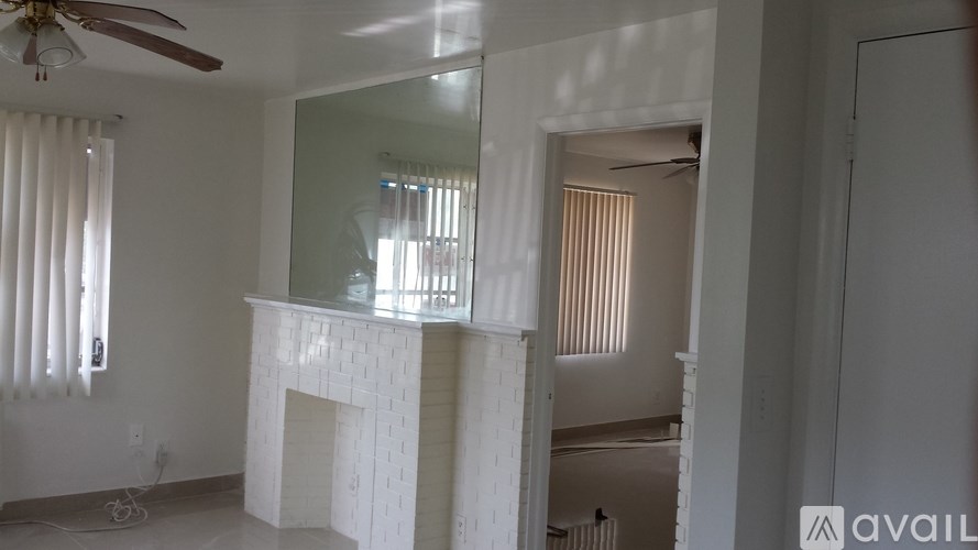 A room with a fireplace and a mirror on the wall.