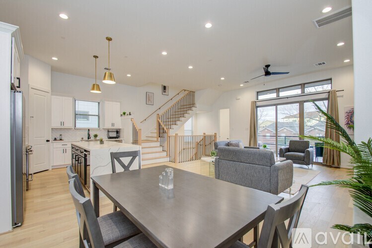 A modern kitchen with a dining table and chairs.