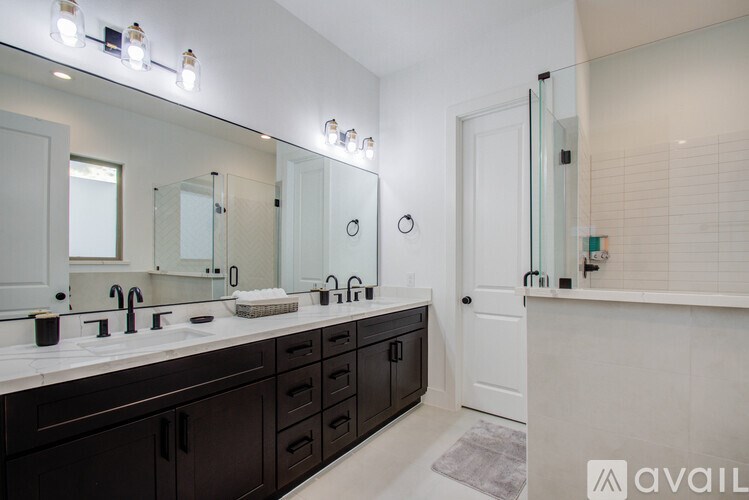 A bathroom with a vanity and a mirror above it.