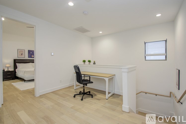 A room with a desk and a chair.