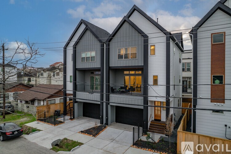 A modern house with a car parked in front.