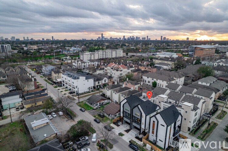 A bird's eye view of a residential area with a red marker on one of the houses.