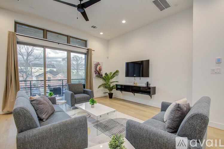 A living room with grey couches and a television.