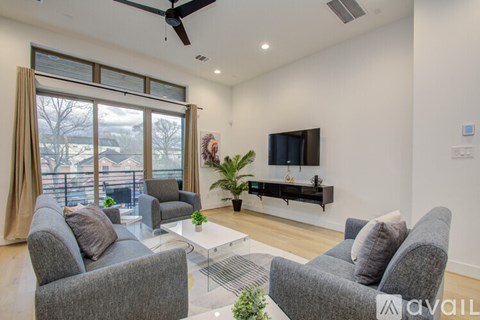 A living room with grey couches and a television.