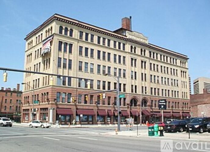 A large building with a red brick facade and a white trimmed window.