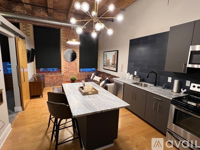 A modern kitchen with a dining table and chairs.