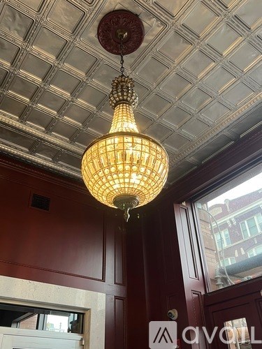 A chandelier with a brownish hue is hanging from the ceiling.