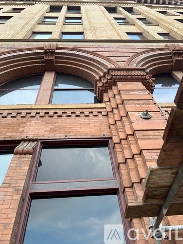 A tall building with a large window and a balcony.