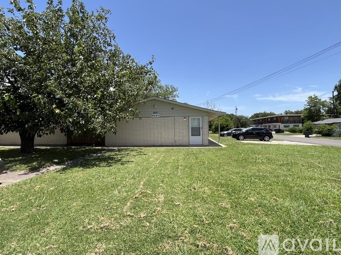 A small building with a tree in front of it.