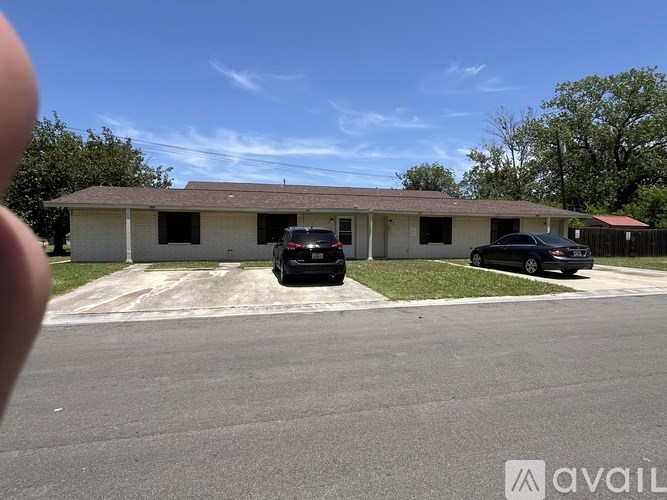 A building with a car parked in front of it.