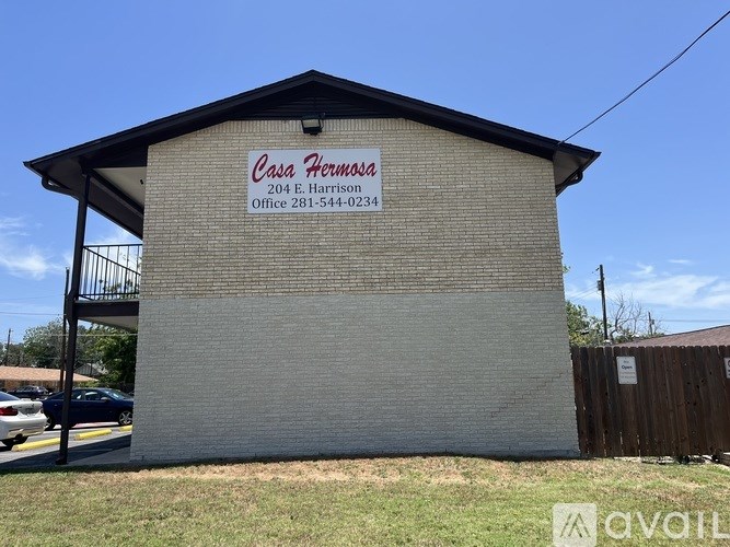 A building with a sign that says "Casa Hernosa" on it.