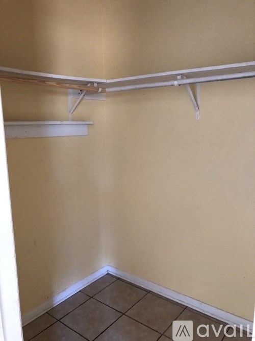 A room with a white shelf and a white wall.