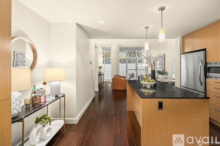 A modern kitchen with wooden cabinets and a black countertop.
