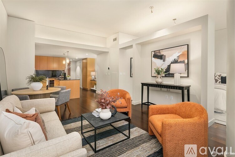 A living room with a sofa, armchair, and coffee table.