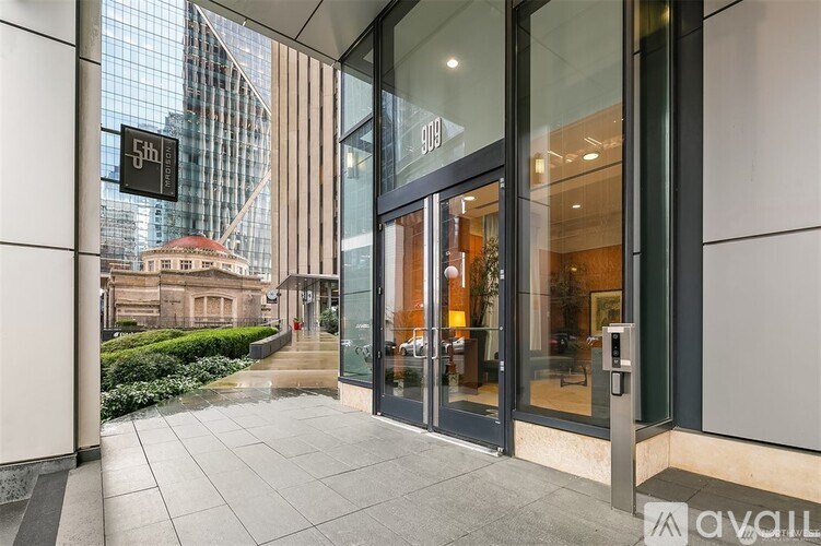 The image shows the entrance to a building with a glass door and a sign that reads "5th Floor".