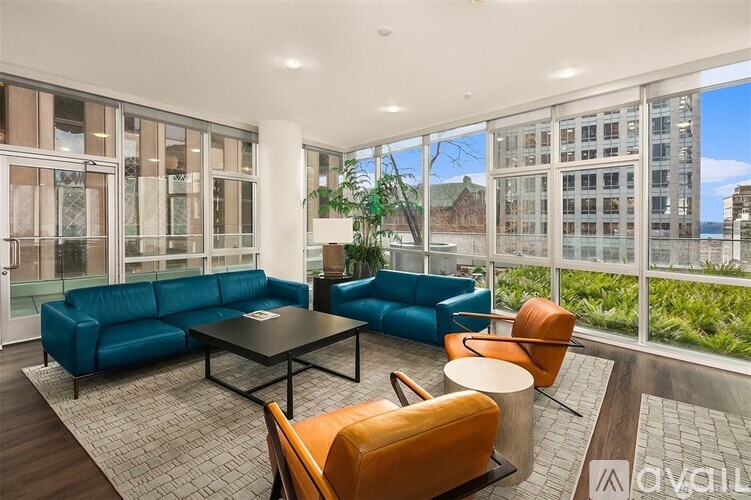 A living room with a blue couch and a coffee table.