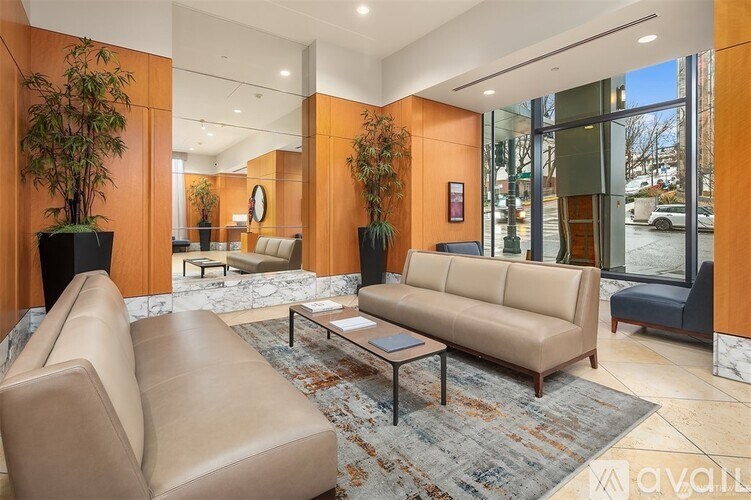 A living room with a beige couch and a coffee table.
