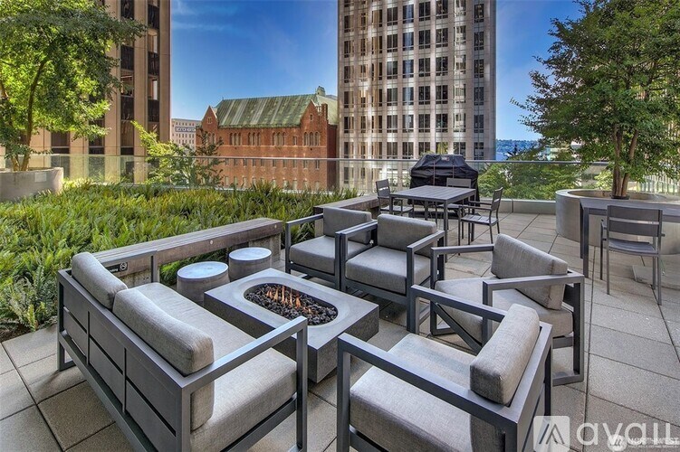 A patio with a fire pit and seating area.