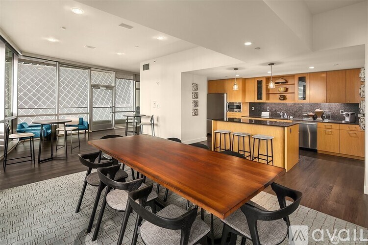 A modern kitchen with a wooden dining table and chairs.