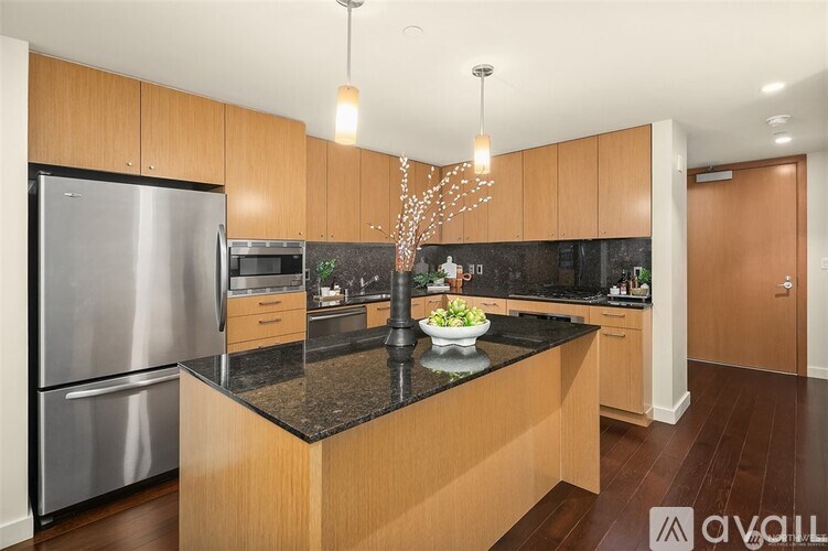 A kitchen with wooden cabinets and a granite countertop.