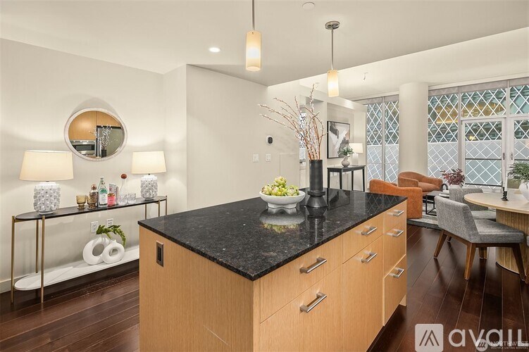 A kitchen with a black countertop and wooden cabinets.