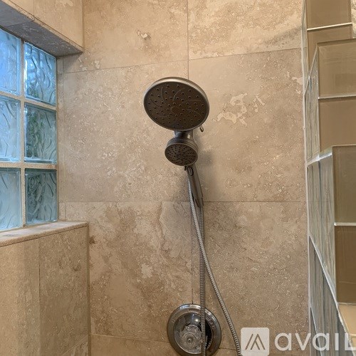 A shower head with a hose attached to it.