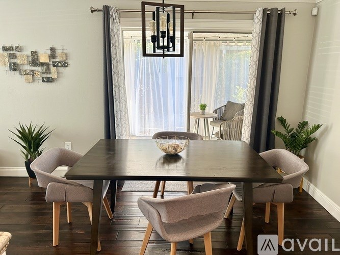 A modern dining room with a large table and chairs.