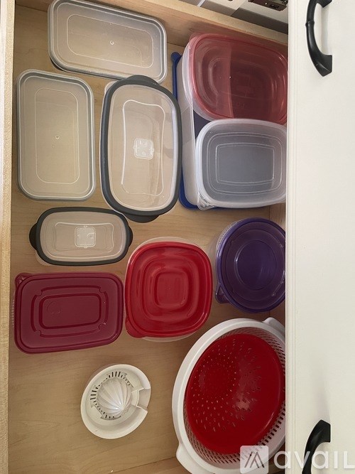 A shelf with a variety of square and round containers in different colors.