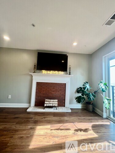 A living room with a fireplace and a tv above it.