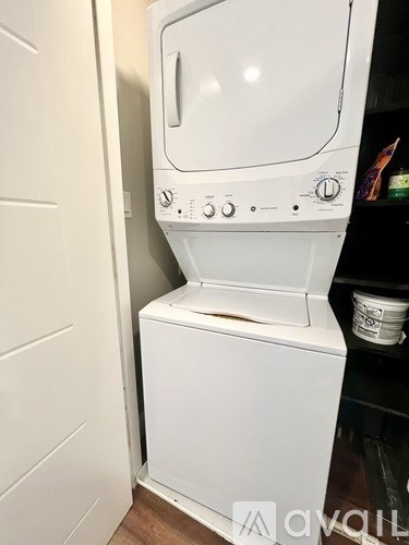 A white washing machine in a small room.