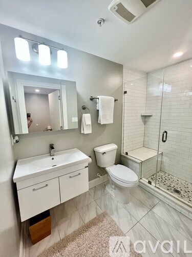A bathroom with a sink, toilet, and shower.
