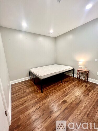 A bedroom with a bed and a small table.