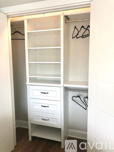 A white closet with drawers and shelves.